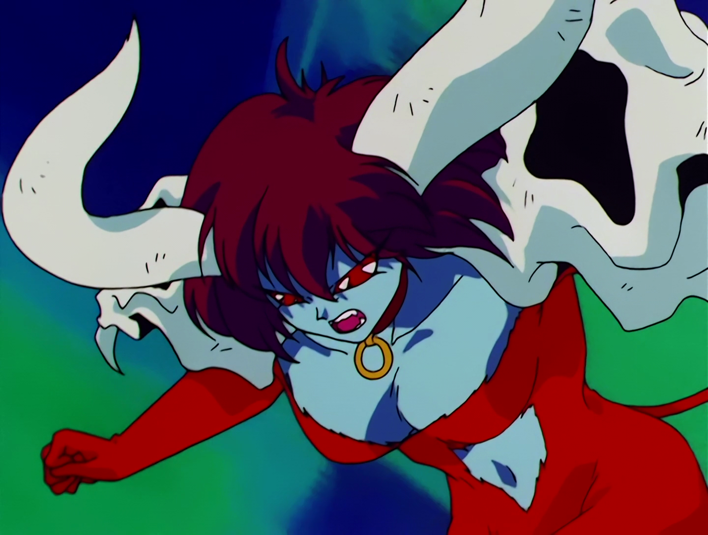 Minotauron, a Cardian from Sailor Moon episode 48. She has light blue skin, red eyes and brown hair. She has large white bull horns on her head, wears animal skulls on her shoulders, and her form-fitting outfit is orange. Or maybe that’s just fur, she’s kind of riding that line, furry-wise.